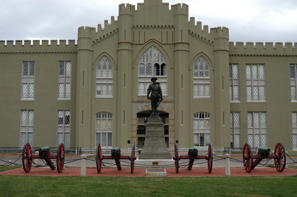 A military institute with a statue in front of it.