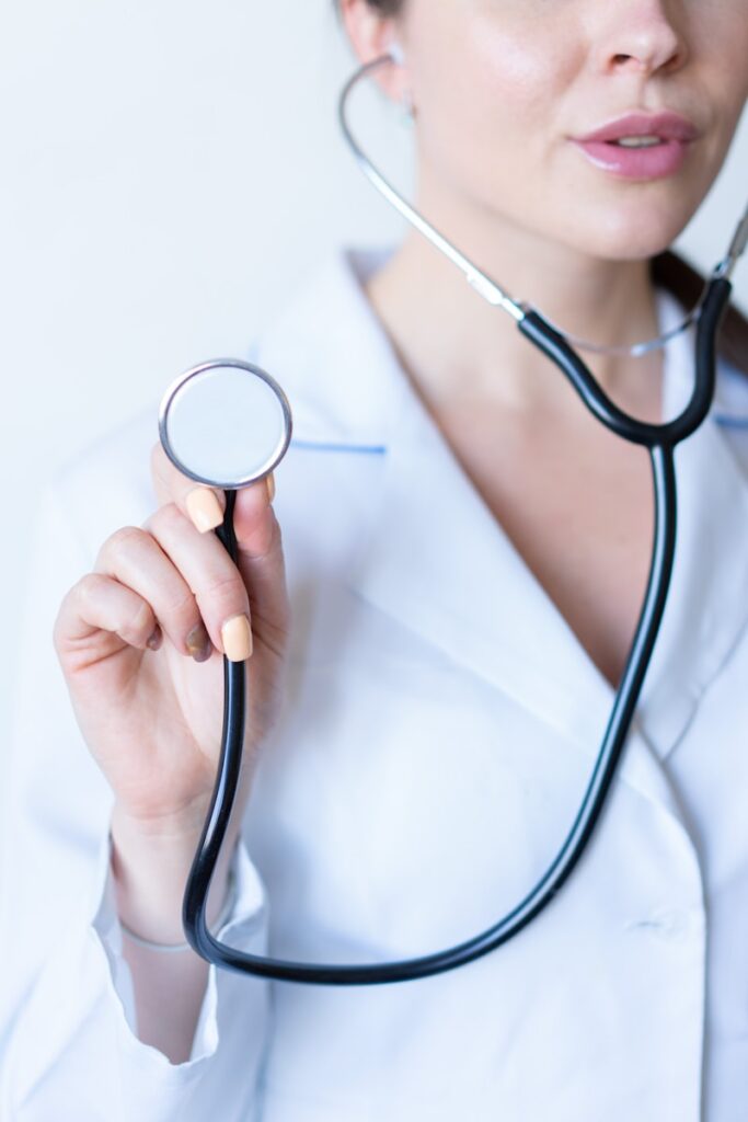 a nurse in a white shirt holding a stethoscope